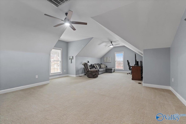 living area with lofted ceiling, ceiling fan, and light colored carpet