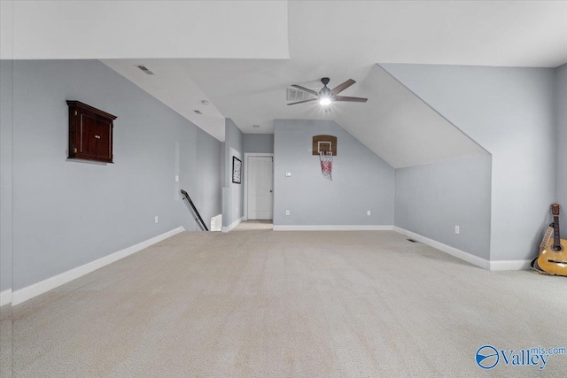 bonus room with ceiling fan, vaulted ceiling, and light colored carpet