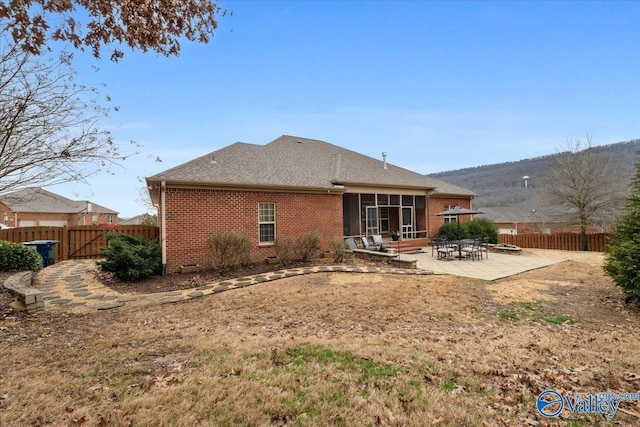 back of house featuring a patio area and a sunroom