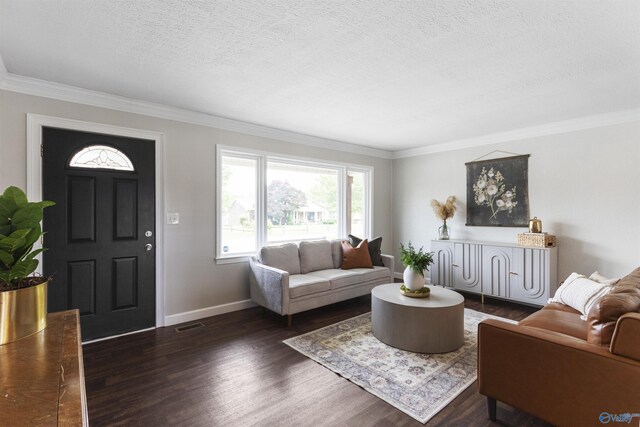 living room featuring ornamental molding, a textured ceiling, dark wood-style flooring, and baseboards