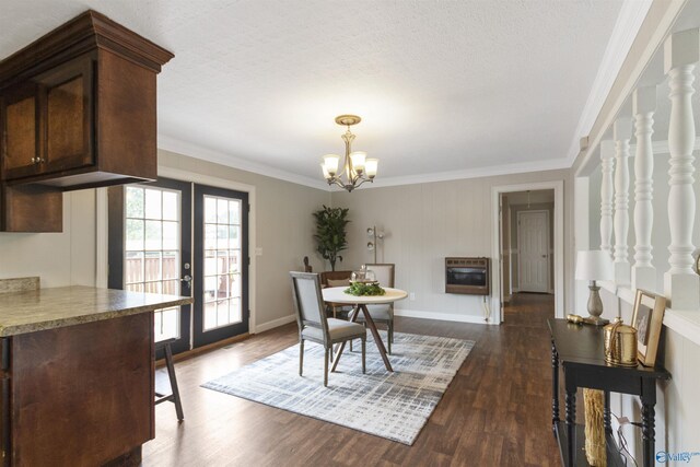 dining space with dark wood-style floors, heating unit, ornamental molding, french doors, and a notable chandelier