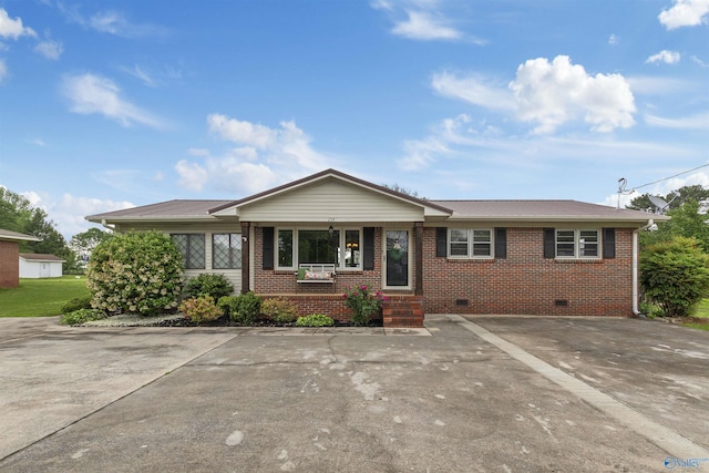 single story home featuring metal roof, a porch, crawl space, and brick siding