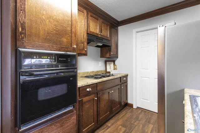 kitchen with stainless steel appliances, under cabinet range hood, dark brown cabinetry, ornamental molding, and dark wood finished floors