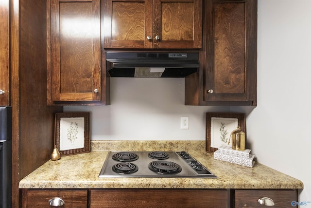 kitchen featuring dark brown cabinets, stainless steel electric stovetop, and under cabinet range hood