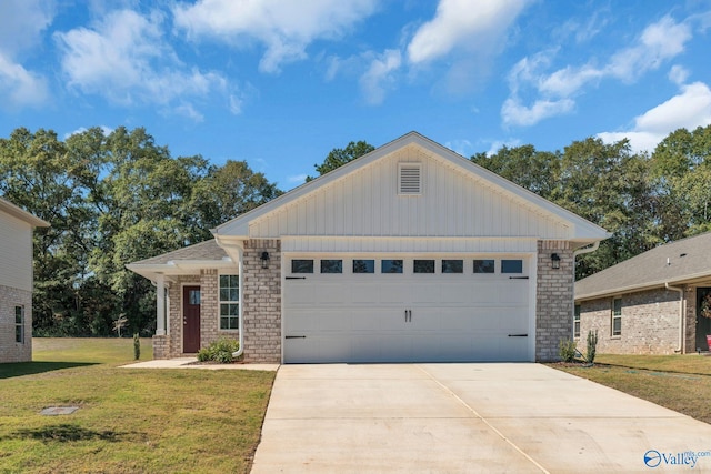 view of front of property featuring a front yard, brick siding, driveway, and an attached garage