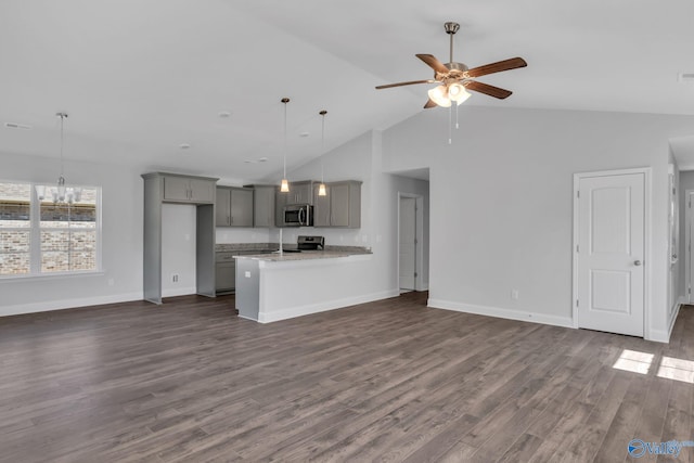 kitchen with gray cabinets, light stone counters, stainless steel appliances, and open floor plan