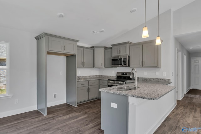 kitchen featuring pendant lighting, stainless steel appliances, dark wood-type flooring, light stone countertops, and a peninsula