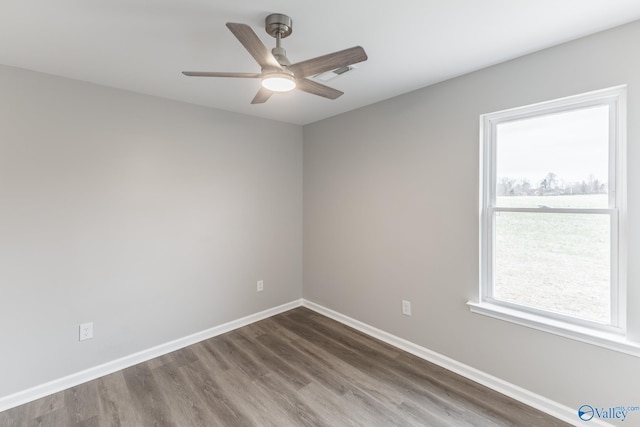 empty room with dark hardwood / wood-style floors and ceiling fan