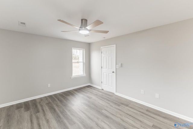 empty room with hardwood / wood-style flooring and ceiling fan