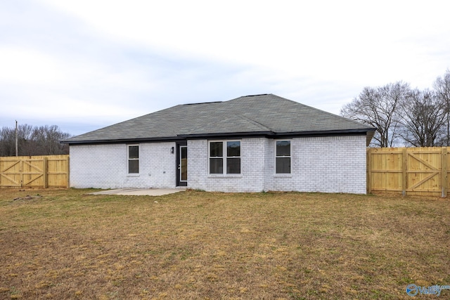 rear view of house with a patio area and a yard