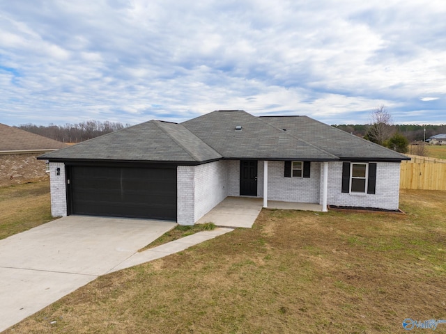 single story home with a garage and a front lawn