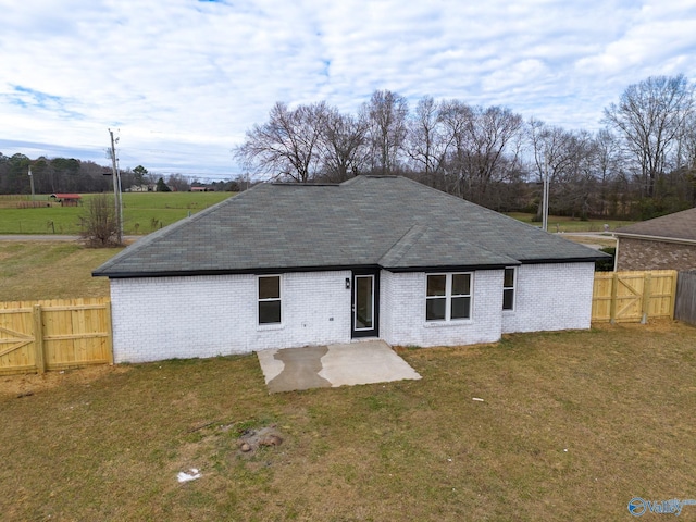 back of property featuring a lawn and a patio area