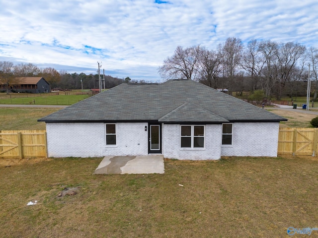 back of house with a yard and a patio area