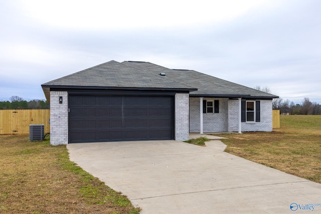 ranch-style home featuring central AC, a front yard, and a garage