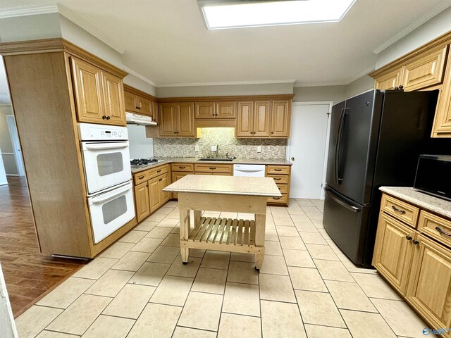 kitchen with light tile patterned flooring, sink, decorative backsplash, ornamental molding, and white appliances