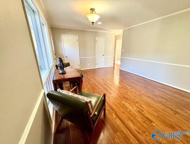 living room featuring hardwood / wood-style flooring and crown molding