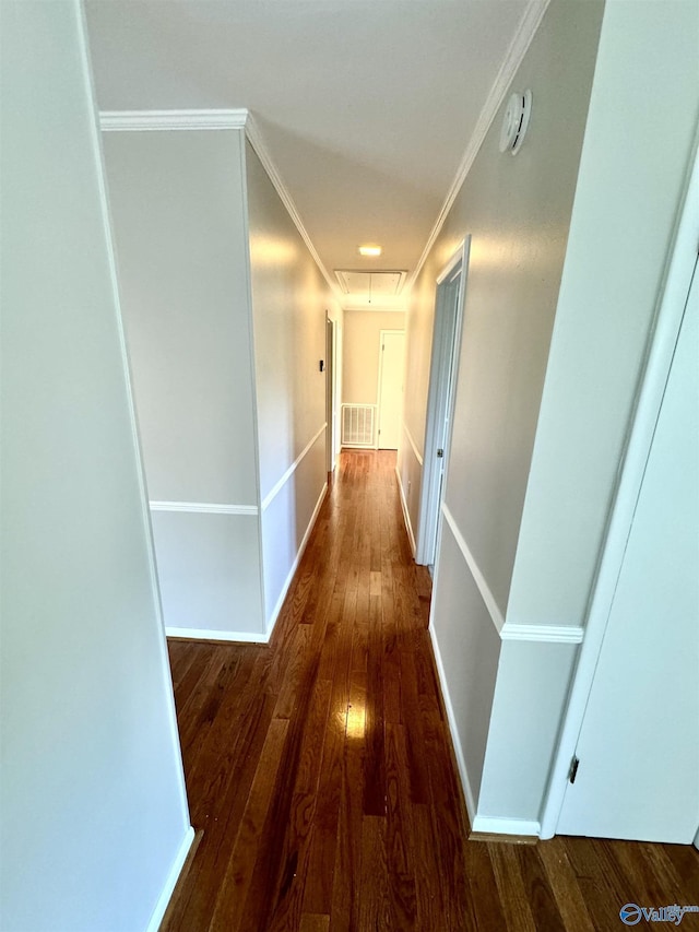 corridor with ornamental molding and dark hardwood / wood-style floors