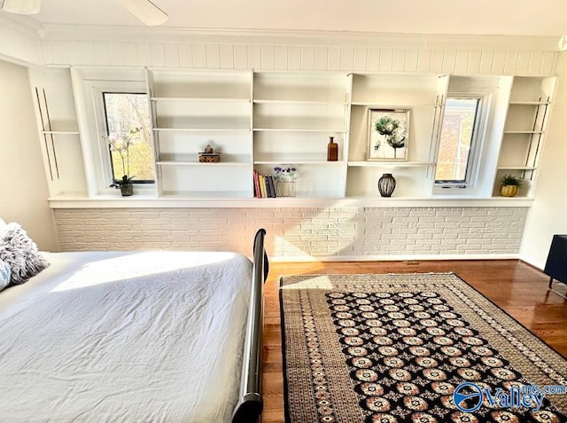 bedroom featuring hardwood / wood-style flooring and ornamental molding