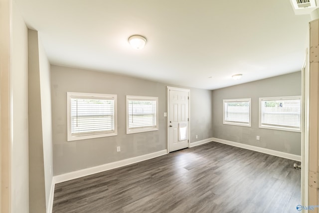entryway with dark wood finished floors, visible vents, and baseboards
