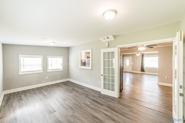 unfurnished room featuring baseboards and dark wood-style flooring