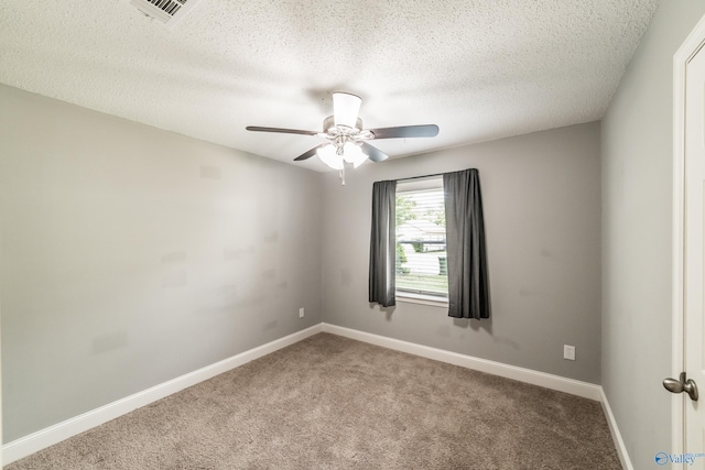 unfurnished room with a textured ceiling, visible vents, carpet flooring, a ceiling fan, and baseboards