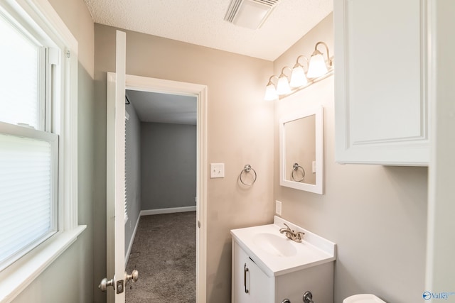 bathroom featuring vanity, visible vents, and plenty of natural light
