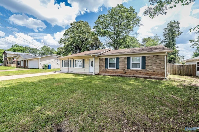 ranch-style house with fence, a garage, brick siding, and a front yard