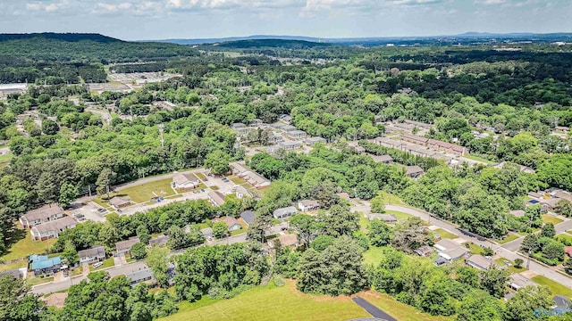 drone / aerial view with a wooded view