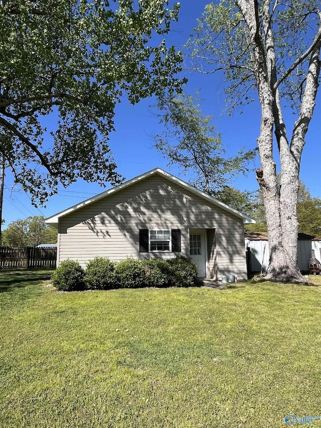 bungalow-style house featuring a front yard and fence