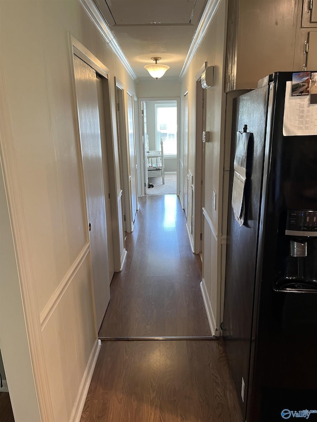 hallway featuring ornamental molding and wood finished floors