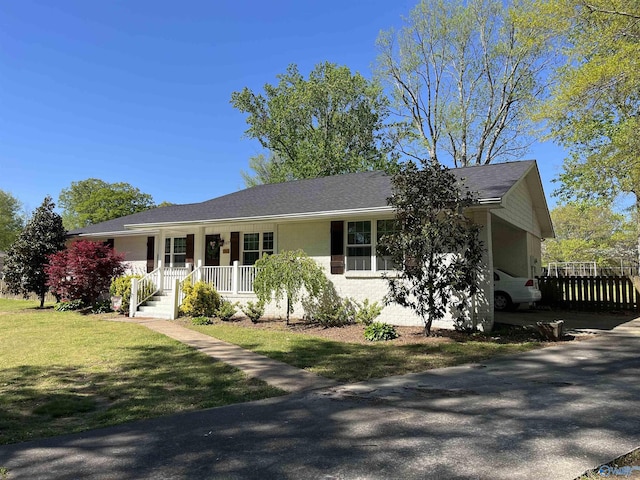 ranch-style house with a front yard, a porch, and fence