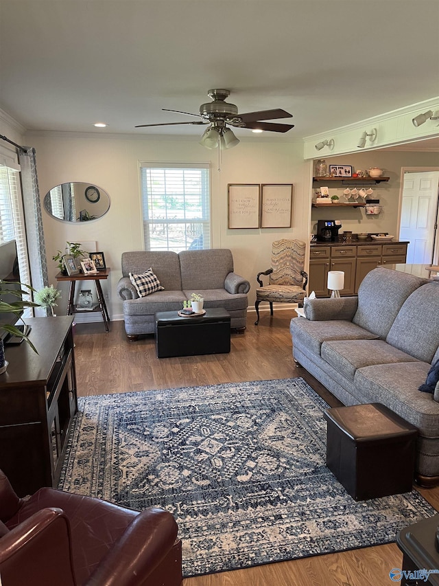 living area with recessed lighting, plenty of natural light, a ceiling fan, and wood finished floors