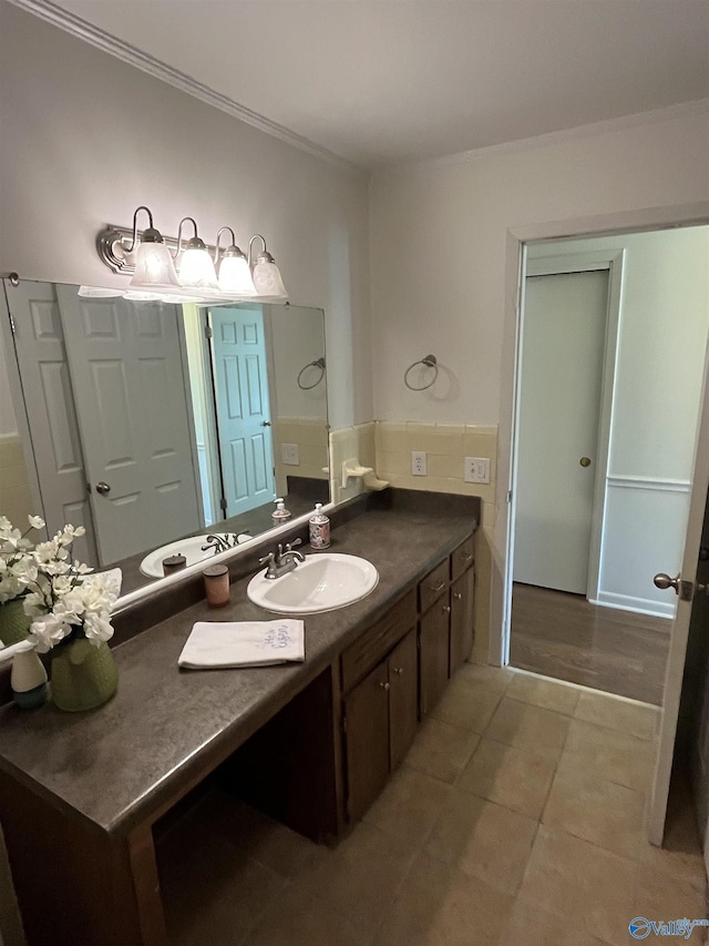 bathroom with tile patterned flooring, vanity, and ornamental molding