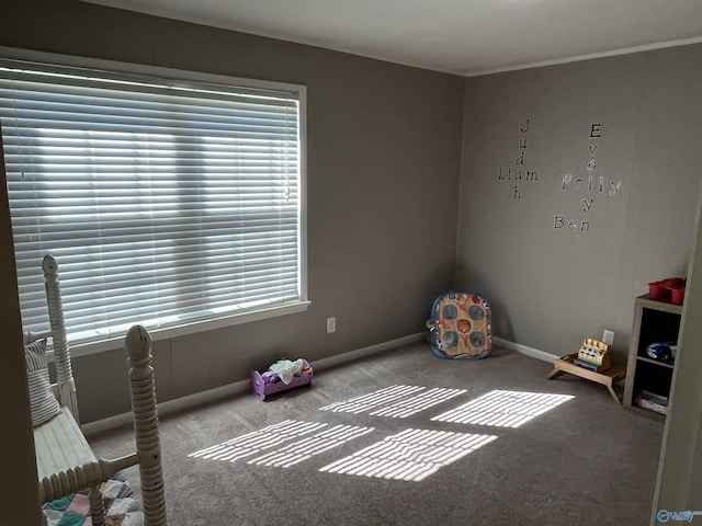 playroom featuring carpet floors, baseboards, and a healthy amount of sunlight
