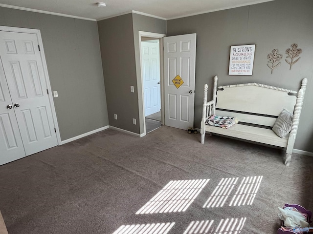 bedroom with crown molding, baseboards, and carpet floors