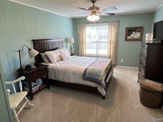 bedroom with crown molding, ceiling fan, light colored carpet, and a textured ceiling
