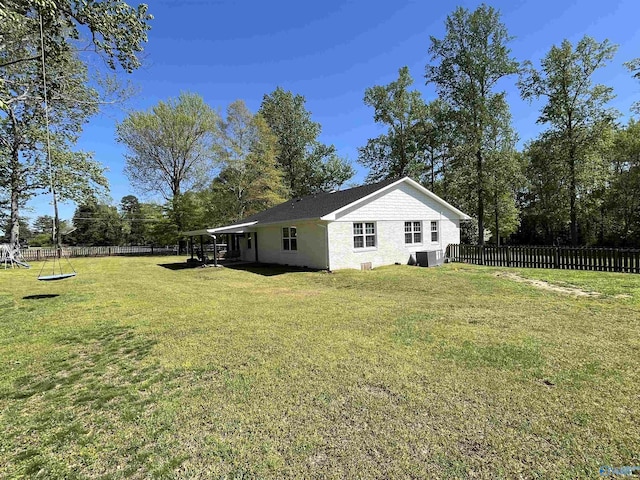 view of property exterior with a yard, a fenced backyard, and stucco siding
