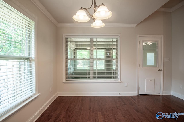 unfurnished dining area with a notable chandelier, ornamental molding, and dark wood-type flooring