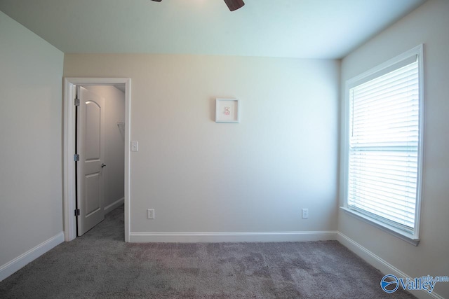 carpeted empty room featuring ceiling fan