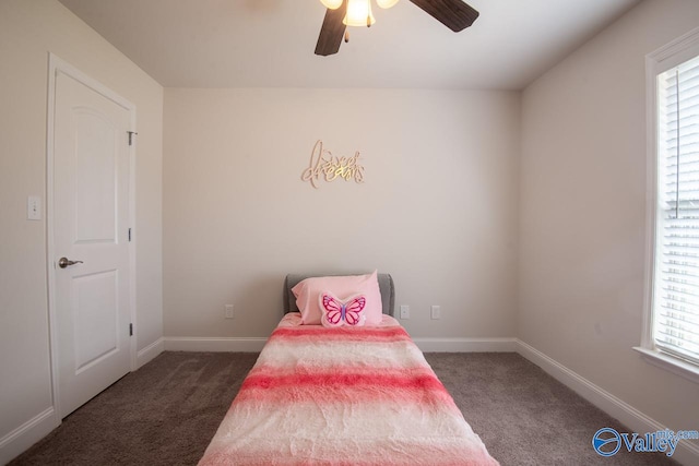 carpeted bedroom with multiple windows and ceiling fan