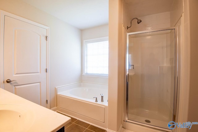 bathroom with tile patterned flooring, vanity, and independent shower and bath