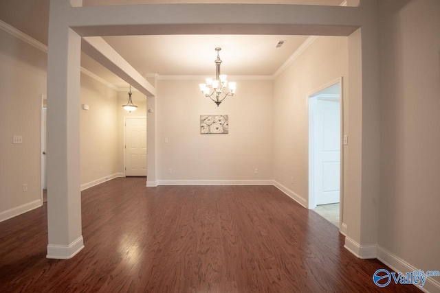 empty room with a chandelier, dark hardwood / wood-style floors, and crown molding