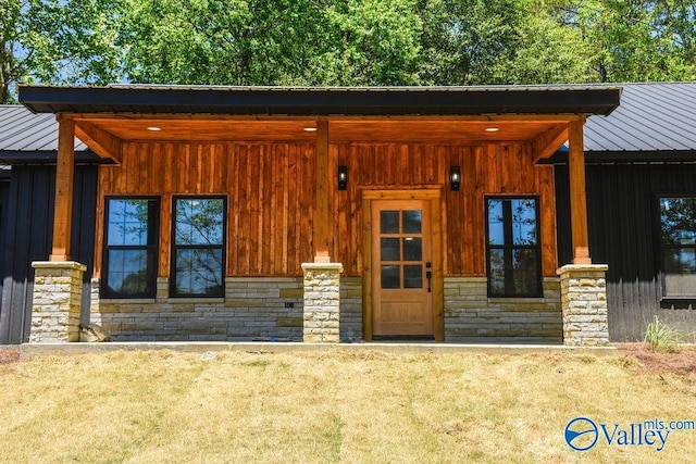 6200 Dalewood Ln, Guntersville, AL 35976 - view of front facade with stone siding, metal roof, and board and batten siding