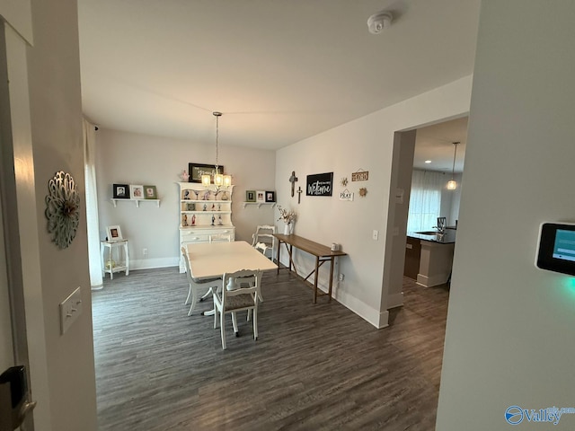 101 River Springs Ct, New Market, AL 35761 - dining room featuring dark wood-style floors, baseboards, and a chandelier