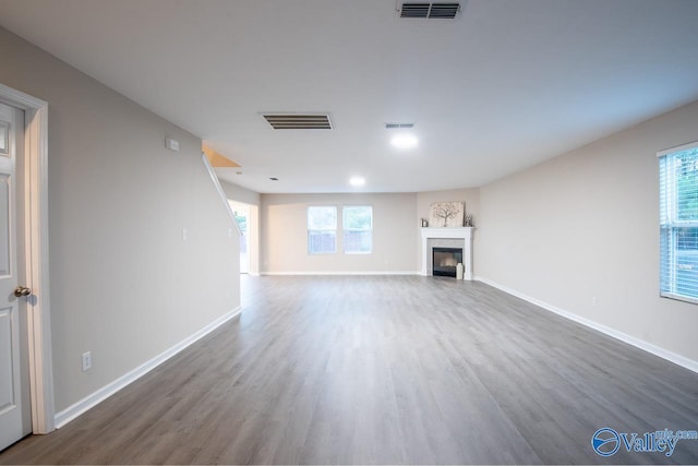 unfurnished living room featuring dark hardwood / wood-style flooring