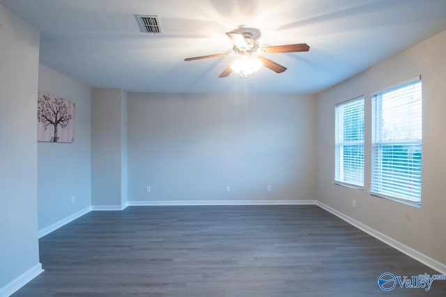 spare room featuring ceiling fan and dark hardwood / wood-style floors