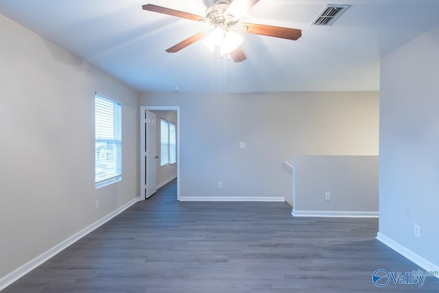 spare room featuring dark wood-type flooring and ceiling fan