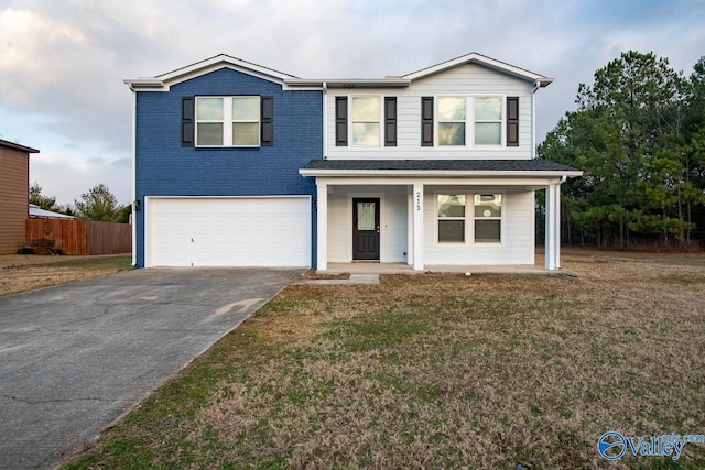 view of front facade featuring a garage, a front lawn, and a porch