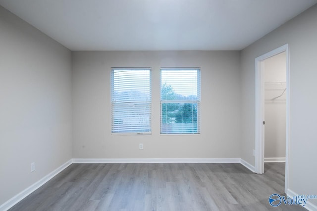 empty room with light hardwood / wood-style flooring