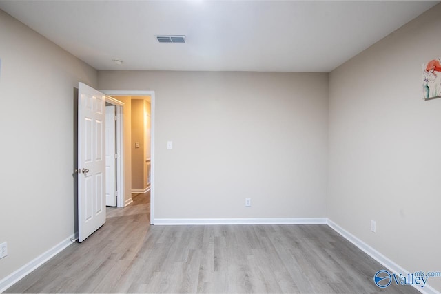 unfurnished room with light hardwood / wood-style flooring